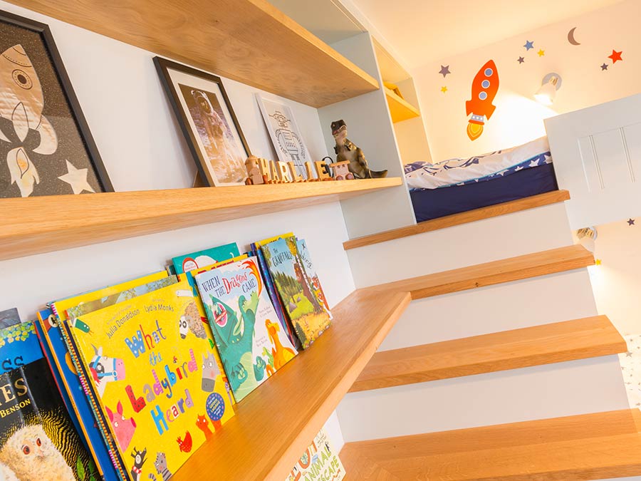 custom shelving integrated onto wall approaching bunk bed