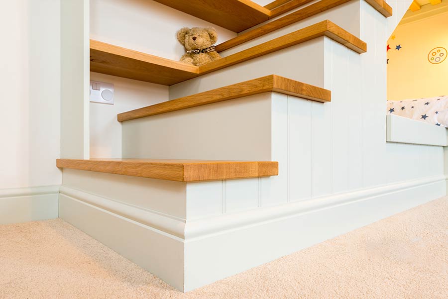 steps up to a bespoke wooden bed